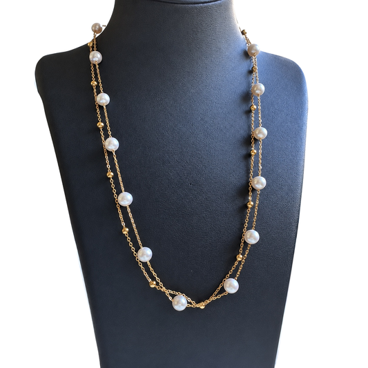 YUKI Double Chain freshwater pearl necklace with spaced white pearls and small gold-plated beads, displayed on a black jewelry bust.
